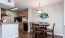 a kitchen with a dining table and chairs