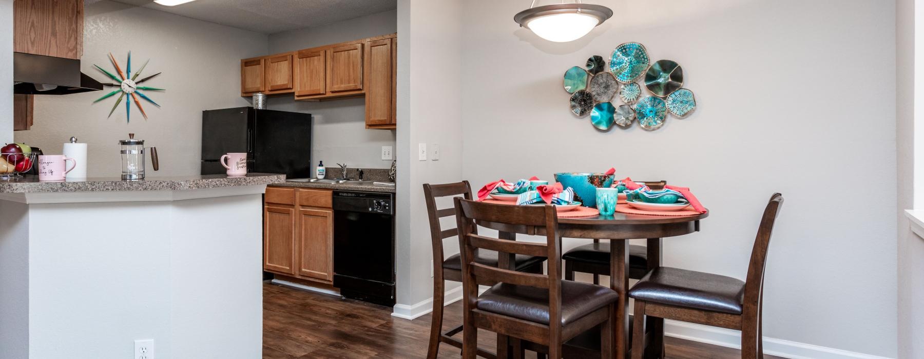 a kitchen with a dining table and chairs